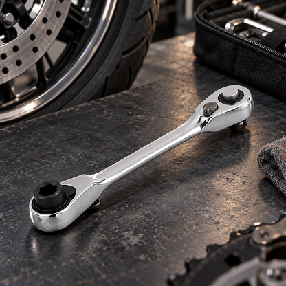 Pocket double-end ratchet wrench beside a motorcycle wheel