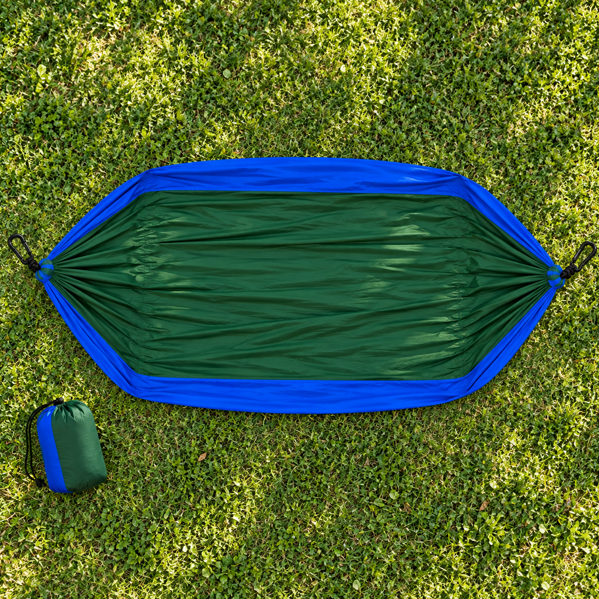Full green and blue hammock laid open on grass